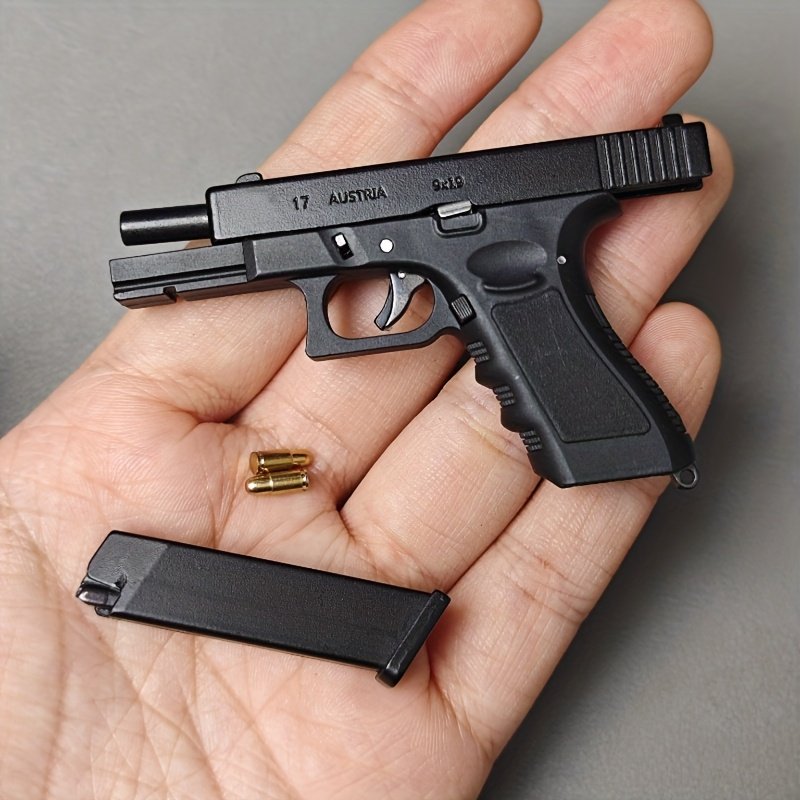 9c9caed8-c850-4d4f-a3ee-89c86589a049.jpg Mini Alloy G-17 Pistol Keychain - Realistic Black & Golden Metallic Design, Removable Key Ring, Durable Zinc Alloy, Stylish Portable Gift for Gun Enthusiasts, Gun Accessories, Key Organizer, Sleek Metallic Finish, Intricate Detailing - Image 1
