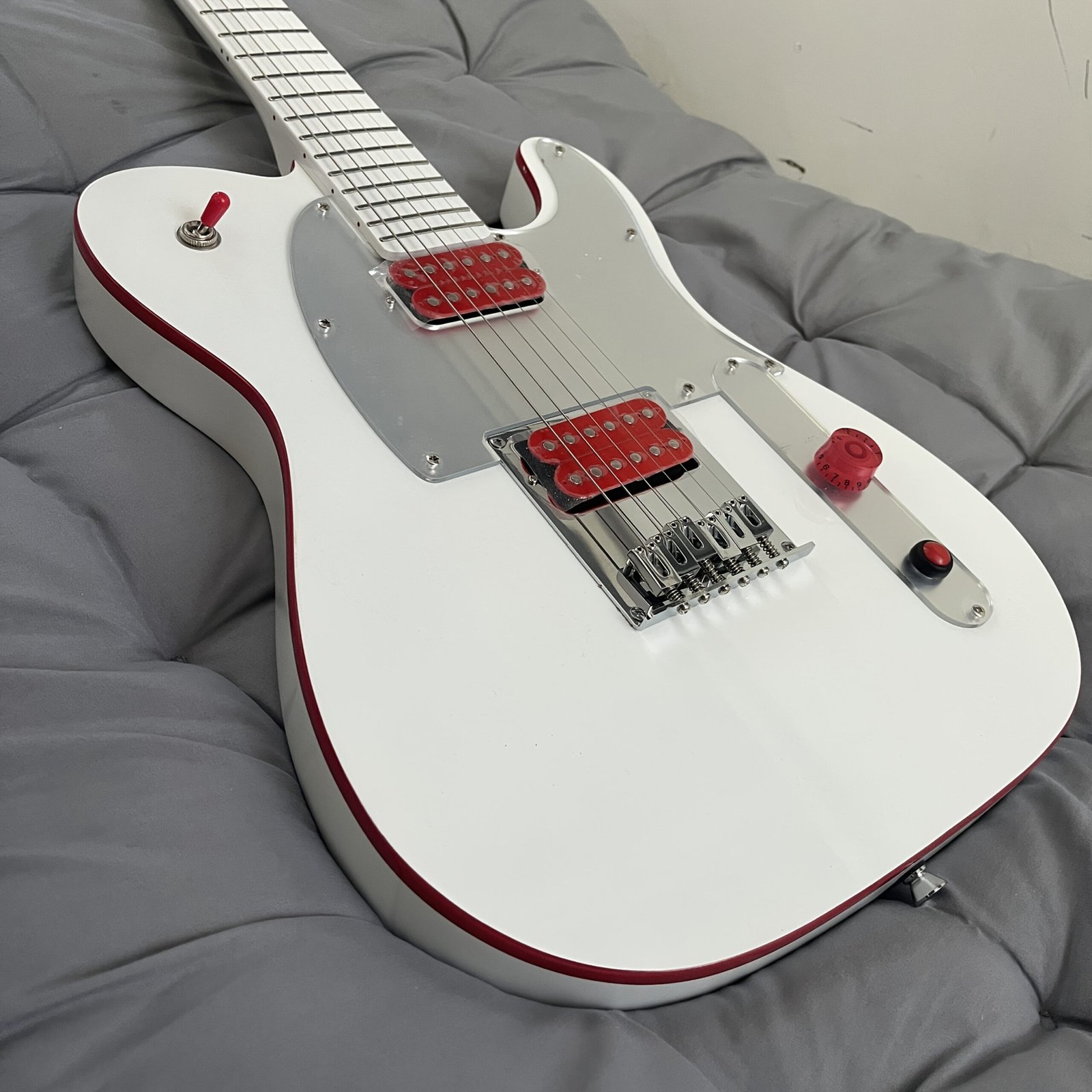 e11f2a3d-e53d-4468-882e-ec745d603b52-scaled-1.jpg 1-Pickup TL Electric Guitar - Arctic White with Red Trim, Ergonomic Neck & Low-Noise Bridge, Kill Switch System, (36V) for, Pop, Metal Music - Ideal for Beginners & Pro Musicians - Operation, Compact & Portable, Arcade Style with Red Switches & Black Fretboard-like Design, White Body & Red Trim, Power Supply Not Included - Guitar - Image 1